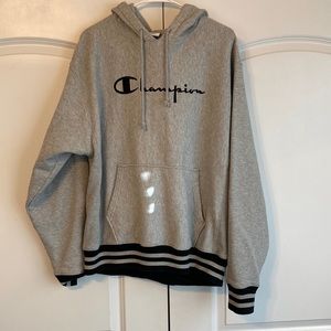Grey champion hoodie with black stripes around the wrist and waist